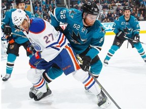 Matt Irwin #52 of the San Jose Sharks battles for the puck against Boyd Gordon #27 of the Edmonton Oilers during an NHL game on February 2, 2015 at SAP Center in San Jose, Calif.