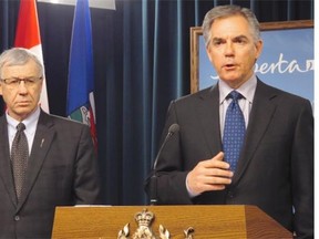 Premier Jim Prentice and Finance Minister Robin Campbell, left, announced on Feb. 11, 2015, that the province is looking at a nine per cent cut to departmental spending in the next budget, due to the collapse in oil prices.