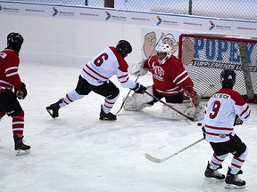 14-year-old Cody McCormack looks on as players skated in to action at the start of the 10-day World's Longest Hockey game to raise funds for the Alberta Cancer Foundation at Saiker's Acres east of Sherwood Park on Friday Feb. 6, 2015.