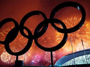 The Olympic Rings are silhouetted as fireworks light up the sky during the closing ceremonies at the 2014 Winter Olympics in Sochi, Russia, on Feb. 23, 2014.