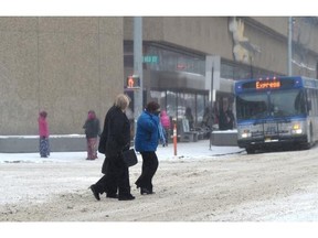 Pedestrians trudge through the cold snow day downtown in Edmonton , February 2, 2015.