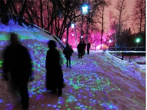 People walk through a magically lit landscape during City of Light, The Flying Canoe Adventure in Mill Creek Ravine in Edmonton on Friday, Feb. 1, 2013.