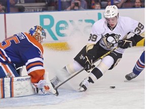 Pittsburgh Penguins and former Oiler David Perron (39) loses the puck in front of Edmonton Oilers goalie Viktor Fasth (35) during NHL action at Rexall Place in Edmonton, February 4, 2015.