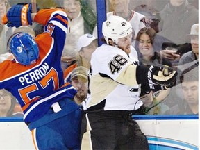 Pittsburgh Penguins’ Joe Vitale, right, checks Edmonton Oilers’ David Perron during first period NHL action at Rexall Place on Friday, Jan. 10, 2014.