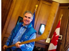 Premier Jim Prentice reminisces about his youth trudging to the neighbourhood rink while holding a Northlands 1940 hockey stick in his office.