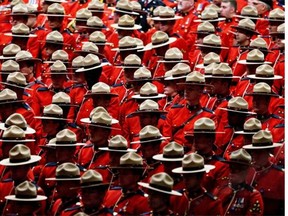 RCMP officers attend the funeral procession for slain RCMP Const. David Wynn, in St. Albert on Jan. 26, 2015. The killing has spawned a review of police officers' role in conducting bail hearings.