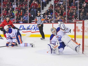 The last of four consecutive third-period goals by Calgary Flames sails into Edmonton's net to seal Oilers' 4-2 defeat.