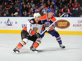 Edmonton Oilers rookie Jordan Oesterle, playing in his first NHL game, battles former Oiler Andrew Cogliano, playing his 600th.