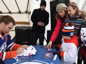 Edmonton Oilers forward Taylor Hall signs autographs as he makes a special visit to players and supporters of The World's Longest Hockey Game.