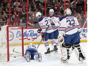 Edmonton Oilers Martin Marincin (85), Boyd Gordon (27), Mark Fayne and goalie Richard Bachman react after a second-period goal by the Ottawa Senators at Canadian Tire Centre on Feb. 14, 2015 in Ottawa. The Oilers lost 7-2.