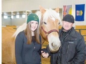Tegan Vickers and her dad, Neil Vickers, a serving member of the Canadian Armed Forces with Bella the horse at the Can Praxis Equine centre in Rocky Mountain House. The program, which helps improve communication between ill and injured soldiers and veterans with PTSD and their families, received $170,000 in support from Wounded Warriors Canada.