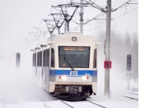 An LRT train heads toward downtown in the falling snow in Edmonton on Friday Jan. 2, 2015. Cities need the right economic tools to take on big projects like mass transit, Paula Simons writes.
