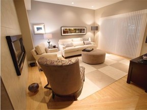 Travertine tile surrounds the modern gas fireplace in Linda Cook’s Glenora home. Interior designer Angelique Case used silvers and creams in gathering spaces to showcase Cook’s art.