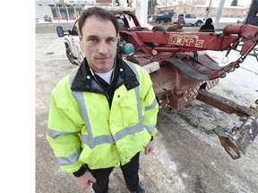 Tow truck driver Rick Gagnon with his truck in Edmonton on Thursday Feb. 12, 2015. Gagnon says it's not worth going downtown to grab cars parked in tow-away zones.