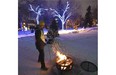 A volunteer stokes the fire during celebrations of the University of Alberta Alumni Association’s 100th anniversary the university held the Green & Glow Winterfest in the Quad area in Edmonton, January 31, 2015. A spectacle of light, fire and snow for this special centenary celebration.