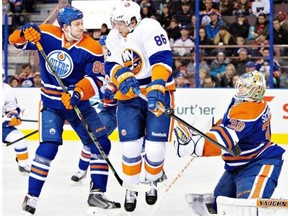 New York Islanders forward Nikolay Kulemin, centre, tries to screen Edmonton Oilers goalie Ben Scrivens on Jan. 4, 2015, at Edmonton’s Rexall Place. The Oilers won the game 5-2.