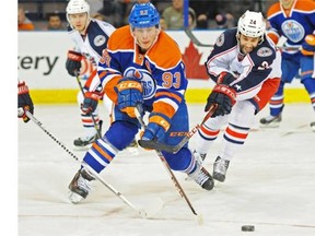 Ryan Nugent-Hopkins battles for a puck against the Columbus Blue Jackets