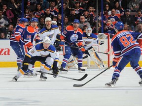 Jordan Oesterle gets set to fire into traffic created by Edmonton Oilers first line of (L-R) Ryan Nugent-Hopkins, Jordan Eberle, and Benoit Pouliot.