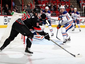 Over here! Elias Lindholm pops one of his three empty net goals as Oilers Justin Schultz and Richard Bachman are slow to react.