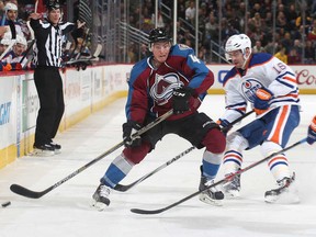 Tyson Barrie #4 of the Colorado Avalanche skates with the puck against Teddy Purcell #16 of the Edmonton Oilers at the Pepsi Center on January 2, 2015 in Denver, Colorado.