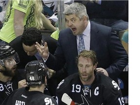 San Jose Sharks head coach Todd McLellan, tops, talks with defenseman Brent Burns (88), center Joe Thornton (19) and center Tomas Hertl (48), from Czech Republic, during the third period of Game 7 of an NHL hockey first-round playoff series against the Los Angeles Kings in San Jose, Calif., Wednesday, April 30, 2014. The Kings won 5-1. (AP Photo)