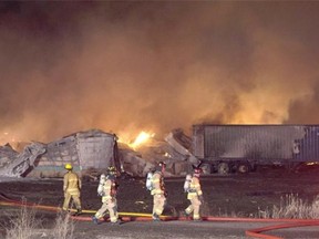 About 40 firefighters battled a large fire on an acreage north of Beaumont on Sunday, March 30, 2015. Four buildings were fully engulfed and water had to be trucked in by tanker.