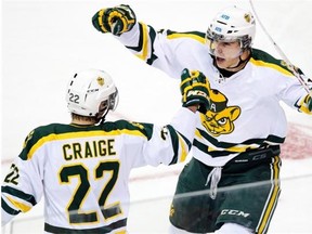 Alberta Golden Bears' Travis Toomey, right, celebrates his goal with teammate Jesse Craige against St. Francis Xavier X-Men, in second period CIS playoff hockey action in Halifax on Friday, March 13, 2015. THE CANADIAN PRESS/Andrew Vaughan