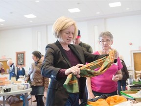 Alberta NDP Leader Rachel Notley examines scarves at the annual rummage sale at Robertson Wesley United Church, where she talked about her party’s plan to unveil its election platform Sunday.