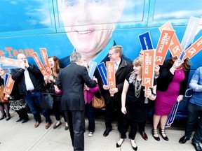 Alberta Premier Jim Prentice is greeted by supporters before boarding his campaign bus in Edmonton on April 7, 2015. Prentice called a provincial election for May 5, 2015.
