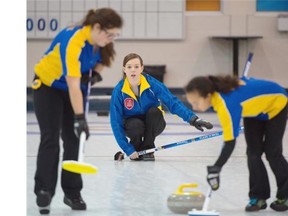 Alberta skip Chantele Broderson watches her rock slide down the ice with sweepers Brenna Bilassy and Madysan Theroux during the juvenile women’s final of the Optimist U18 international curling championships at the Saville Centre on Sunday.
