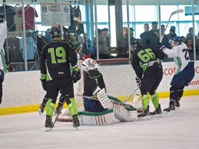 The Alexis Sioux (in white) celebrate a goal against the Frog Lake T-Birds at Edmonton’s Terwillegar Community Rec Centre during the Alberta Native Provincial Hockey championships on April 5, 2015.