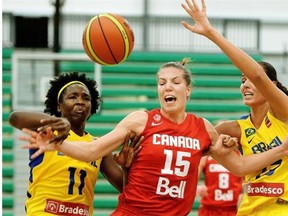 anada’s Michelle Plouffe (middle) and Brazil’s Clarissa Santos (left) and Fabiana Souza (right) battle for the ball during game action in the second game of the inaugural Edmonton Grads International Classic on June 27, 2014.