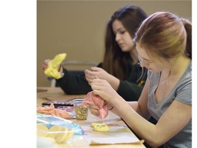 Anastasia Chernyavska (front) and Anna Kuc, both 15, work on Easter cookies at the Killarny Community Hall during the Alberta Council for the Ukrainian Arts’ (ACUA)  Easter Artist & Craft Market and Easter Workshops.