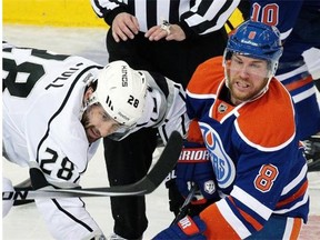 Los Angeles Kings center Jarret Stoll beats Derek Roy of the Edmonton Oilers on a faceoff during Tuesday’s National Hockey League game at Rexall Place.