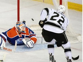 Los Angeles Kings centre Trevor Lewis scores on Edmonton Oilers goaltender Ben Scrivens during the first period of Tuesday’s NHL game at Rexall Place.