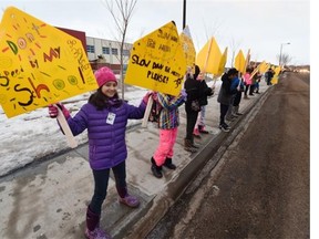 Anna Chernihovesky, 11, and other students from Bessie Nichols and Sister Annata Brockman schools came out with signs urging motorists to slow down in the school zone during a rally in west Edmonton on Monday March 9, 2015.