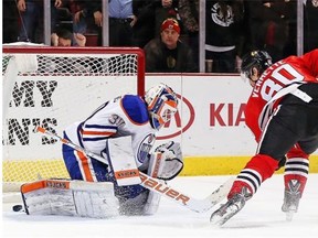 Antoine Vermette #80 of the Chicago Blackhawks scores the game-winning goal in the shootout against Ben Scrivens #30 of the Edmonton Oilers at the United Center on March 6, 2015, in Chicago. The Blackhawks defeated the Oilers 2-1 in a shootout.