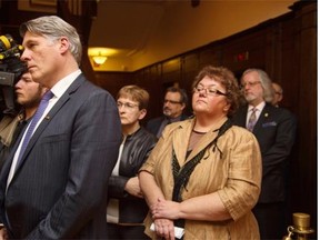 AUPE president Guy Smith, left, and other public-sector union leaders listen to Premier Jim Prentice at Government House in Edmonton following his meeting with them on March 19, 2015.
