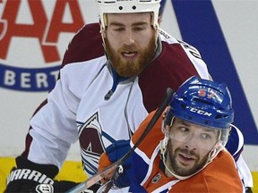 Benoit Pouliot of the Edmonton Oilers gets a stick near his face courtesy of the Colorado Avalanche’s Ryan O’Reilly during Wednesday’s NHL game at Rexall Place.