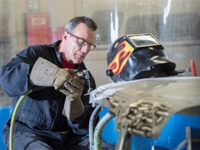 Body repair technician Jim Sieben grinds an aluminum bead he laid down on a hood. Aluminum is becoming more common in newer vehicles and requires specialized tools, processes and skills. Waterloo Ford Lincoln and Empire Collision are joining forces to create Waterloo-Empire Collision, a new auto body repair facility that specializes in aluminum.