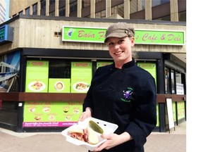 Sarah Ireland, chef at Baba Finks, displays a Montreal smoked meat sandwich sold by the deli inside a former transit kiosk on Jasper Avenue.