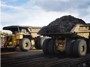 Two heavy hauler trucks at a Syncrude oilsands mine.