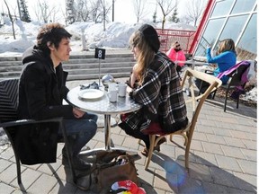 Caitlin Buzzo and Thomas Berkes enjoy the patio on a nice spring day at Cafe’ Bicyclette in Edmonton on Saturday, Mar. 15, 2014. Warm temperatures have returned to Edmonton this year.