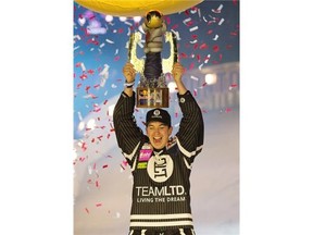 Canadian skater Scott Croxall (2) holds his world championship Red Bull Crashed Ice trophy after finishing second in the race in Edmonton on March 14, 2015.