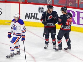 Carolina Hurricanes’ Elias Lindholm (16) of Sweden, celebrates his goal with teammate Victor Rask (49) as Edmonton Oilers’ Justin Schultz (19) skates past during the third period of an NHL hockey game in Raleigh, N.C., Sunday, March 8, 2015, in Raleigh, N.C. The Hurricanes won 7-4.