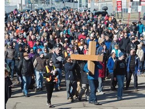 Carrying the orginial wooden cross at the 35th anniversary of the Way of the Cross in Edmonton, April 3, 2015. The march winds its way through the inner city stopping at stations to reflect and think about social issues.