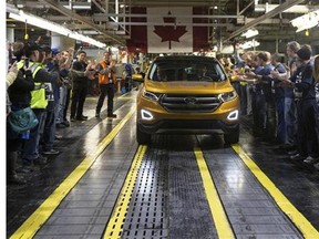 Ford Motor Company President of the Americas Joe Hinrichs, right, and National President of Unifor Jerry Dias drive the first car to the end of the production line as Ford celebrates the global production start of the 2015 Ford Edge at the Ford Assembly Plant in Oakville, Ont., on Thursday, February 26, 2015.