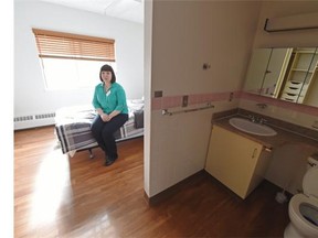 Christina Kane, acting house manager, shows a resident’s room, as Homeward Trust Edmonton and the Schizophrenia Society of Alberta hosted the official grand opening of Iris Court — an affordable, permanent, supportive housing for 21 individuals living with severe and persistent mental illness at 8533-90th Street in Edmonton on Thursday, March 19, 2015.