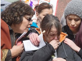 Cindy Gladue’s mother Donna is comforted by friends and family at rally to protest the acquittal of the man accused of killing Cindy Gladue, April 2, 2015.