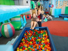 Cohen Zazalak takes a ride on the zip line with the help of John Fehr at My Gym.